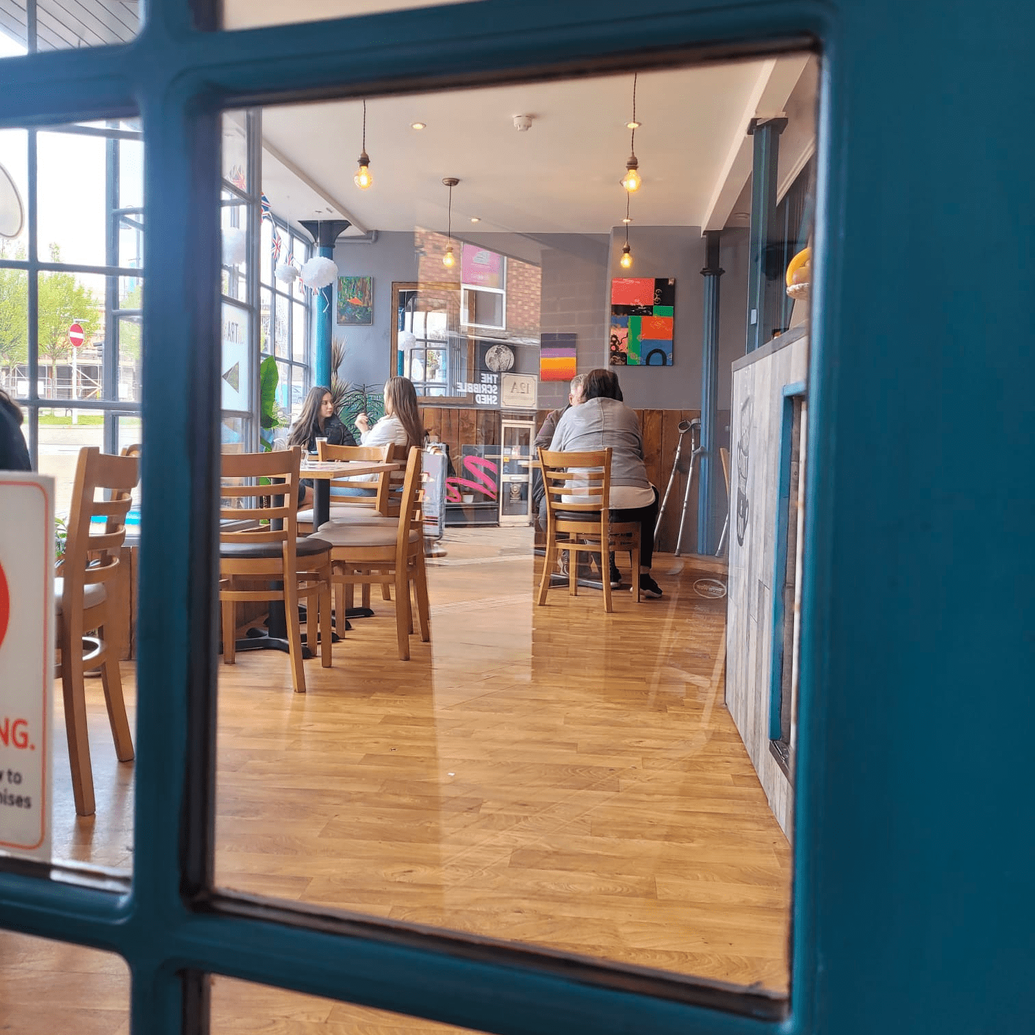 Customers at cafeness drinking coffee..